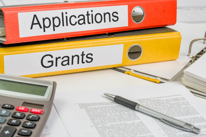 Grant and application binders on a desk, representing nonprofits funding through Cochrane Foundation's Community Capital Grants.