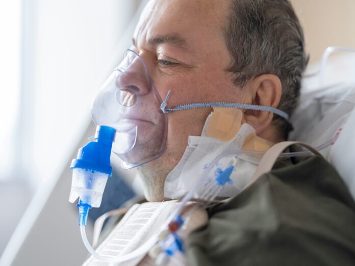 A man lying on the hospital bed for Lung Cancer Research Foundation Grant