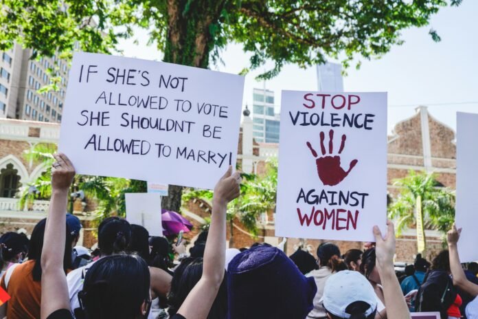 A group of people holding up signs for Funding Feminist Initiatives