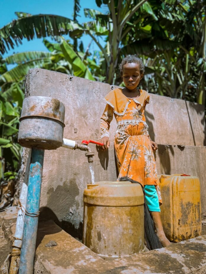 child fetching water from UNDP provided borehole