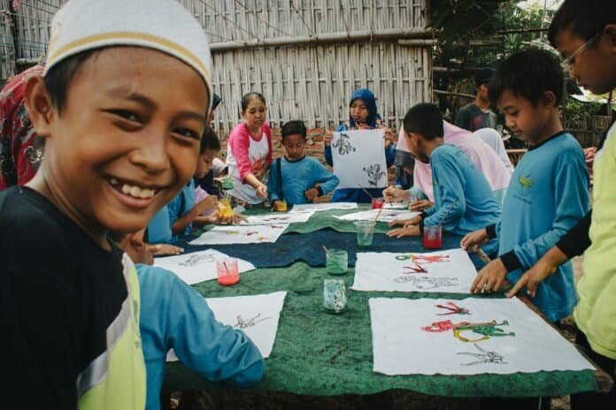 Children painting outdoors to represent the Goodyear Community Fund