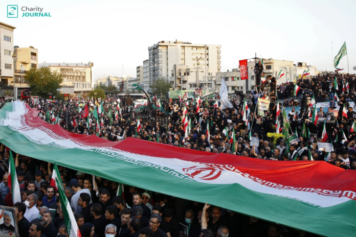 Protesters in Iran holding the national flag during demonstrations