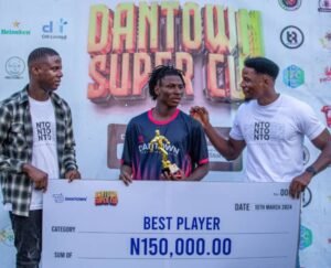 Chimeneh Chinah and Goodnews Igwe handing over cheque to best tournament player