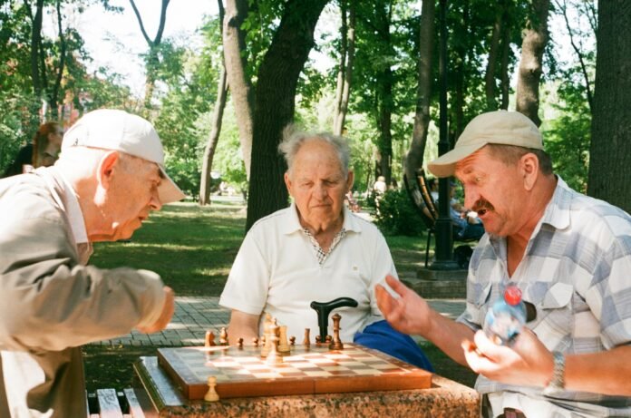 A group of men playing chess to represent Kennedys Group Community Grants Program 2026
