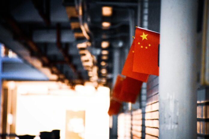 Chinese flag hanging outside a building