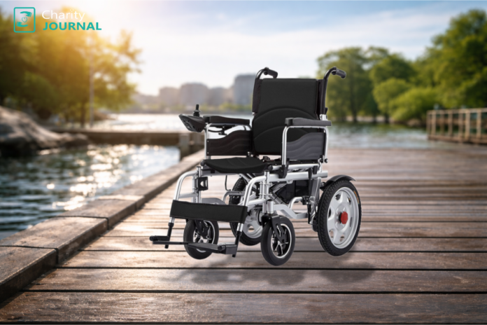 A black motorized wheelchair on a wooden pier