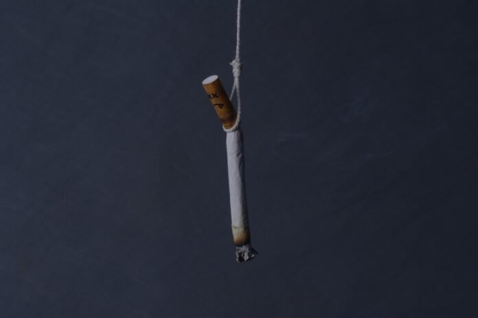 Cigarette hanging by a thread