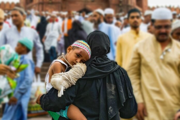 A muslim woman holding a child